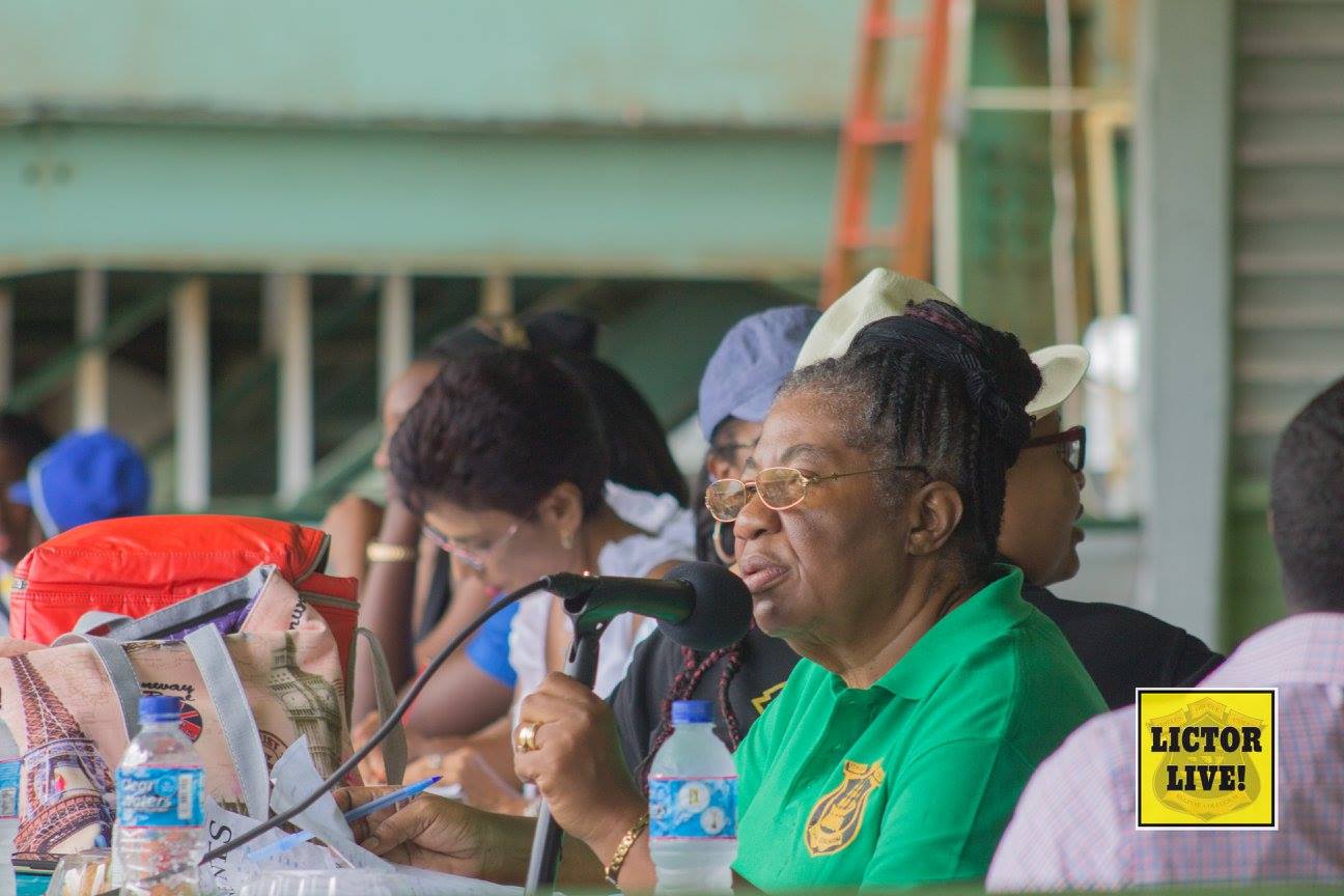 <strong>QC's Sports Commentator</strong><br>In the midst of commentating, here Miss Rohlehr-Vogt is pictured at the Annual Inter-House Sports Championship 2017. Next to her, Miss Bohj is seen feverishly tallying the scores of the races as they come in. Sports is not only about the races; the live commentary breathes life into the event and the hard work of staff is integral to smooth ‘running’ of the day.<br>Photo: <em>Lictor Live!</em> QC's Sports Commentator